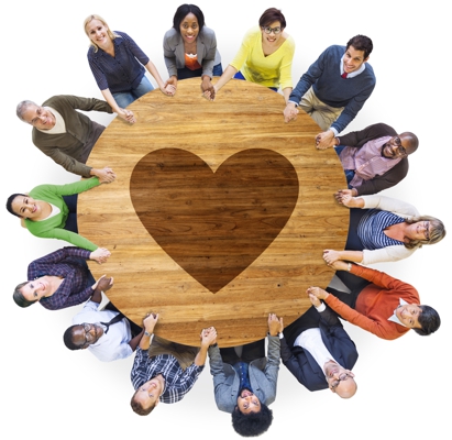 Several people around a table with a heart in the center