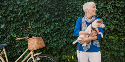 Older woman with dog and bike