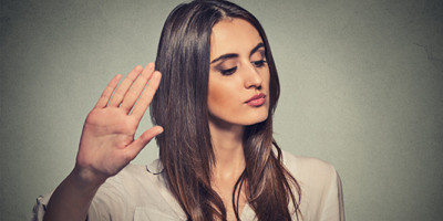 Woman raising hand to say Talk to the Hand