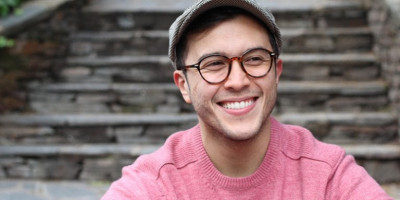man smiling at the base of steps