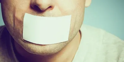 man with white tape over his mouth