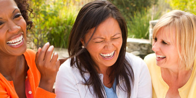 three female friends laughing hard