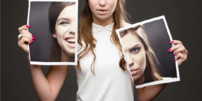 woman holding 2 half photos of herself