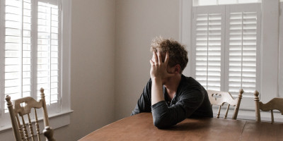 man with head in hands