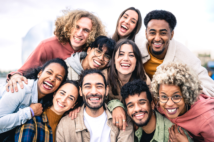 People huddled together smiling