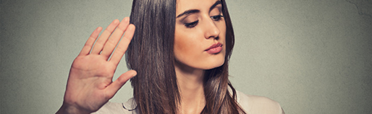 Woman raising hand to say Talk to the Hand
