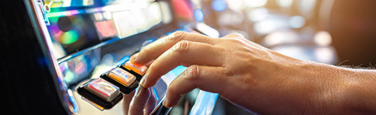 hand pushing gambling slot machine button