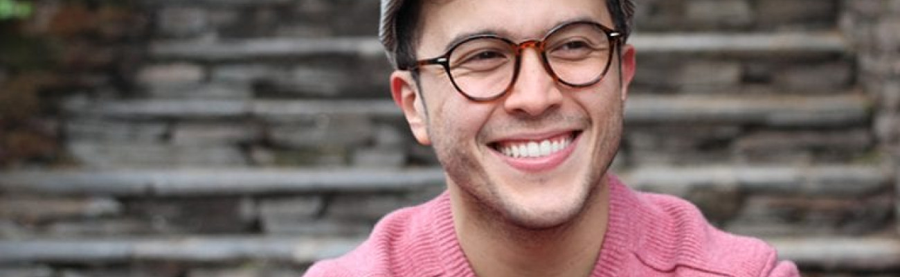 man smiling at the base of steps