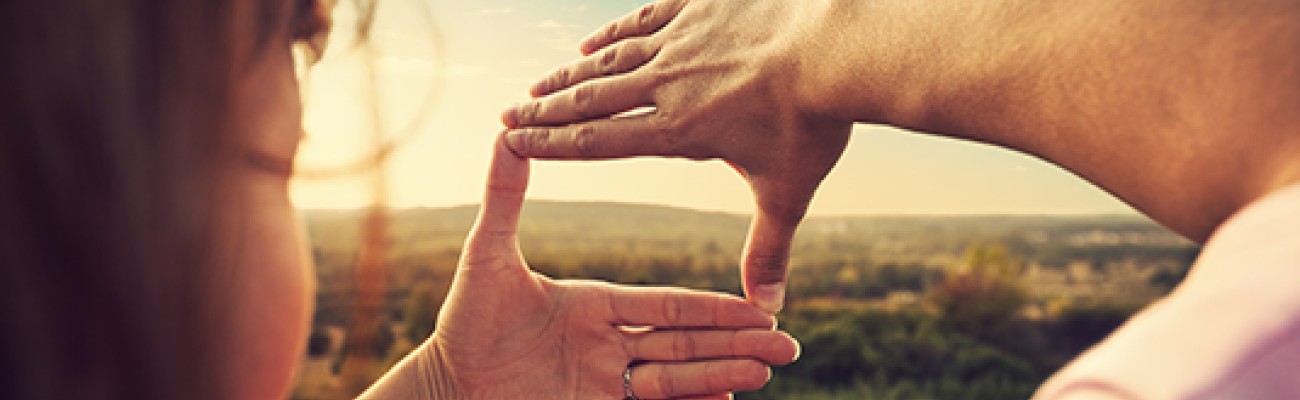 using hands to highlight a section of the countryside for a photo