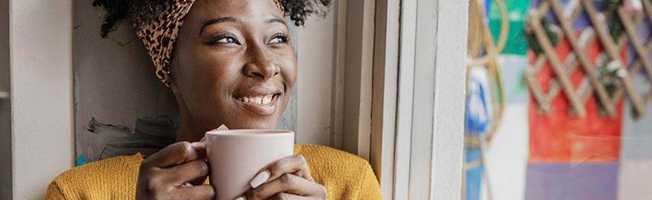 woman smiling drinking coffee or tea