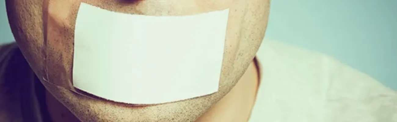 man with white tape over his mouth