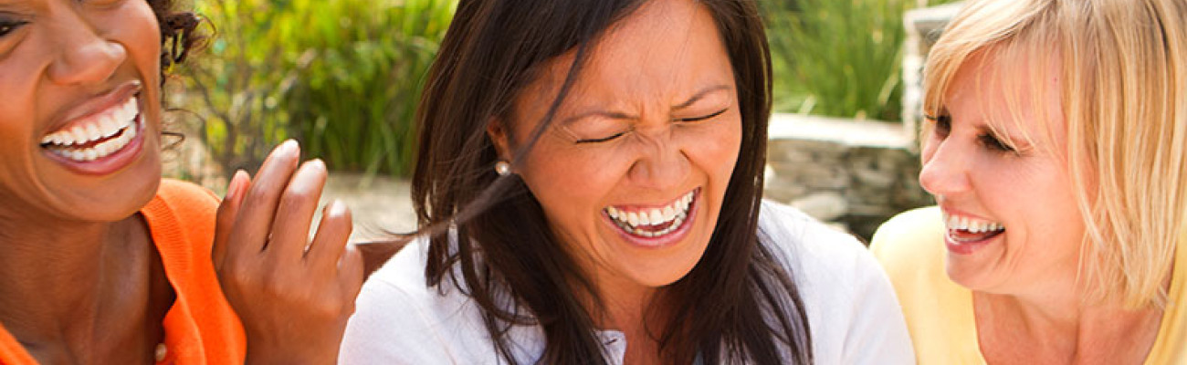 three female friends laughing hard