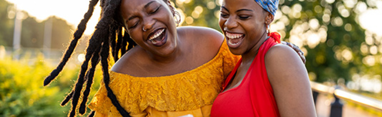 Two female friends hugging and laughing
