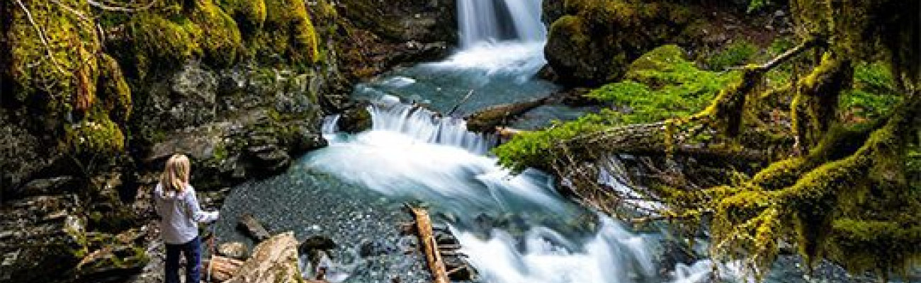 woman beside a waterfall