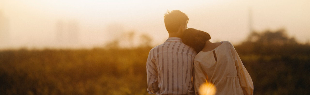 A woman leaning on a mans shoulder