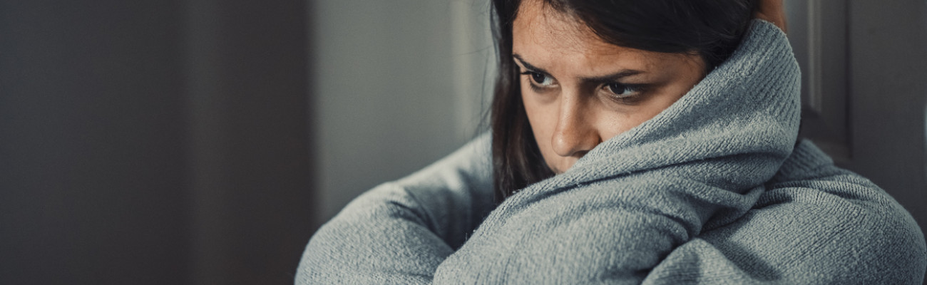 A woman with her head tucked in her arms